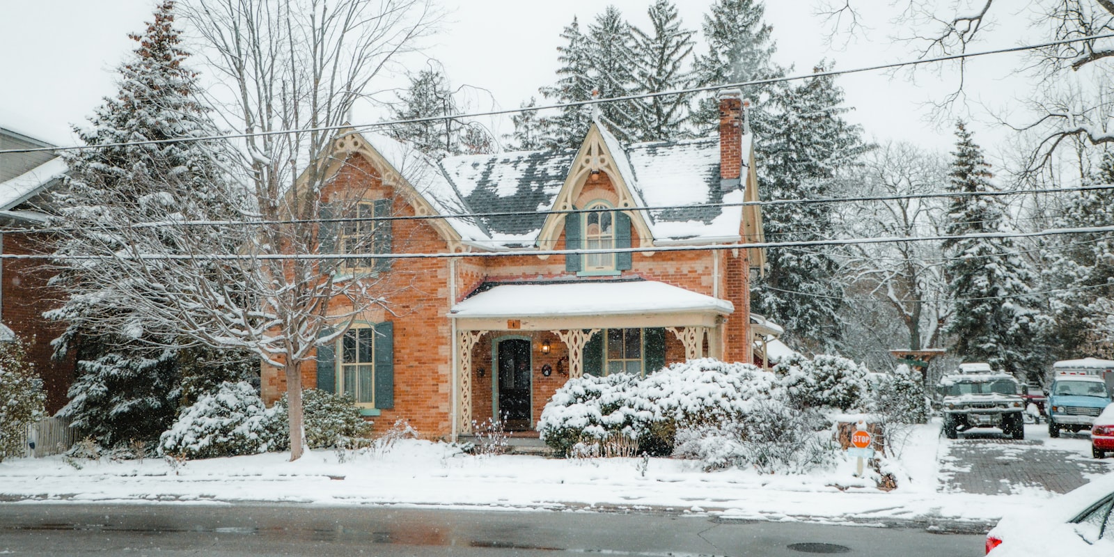 Red brick Ontario home under heavy snow on a residential street